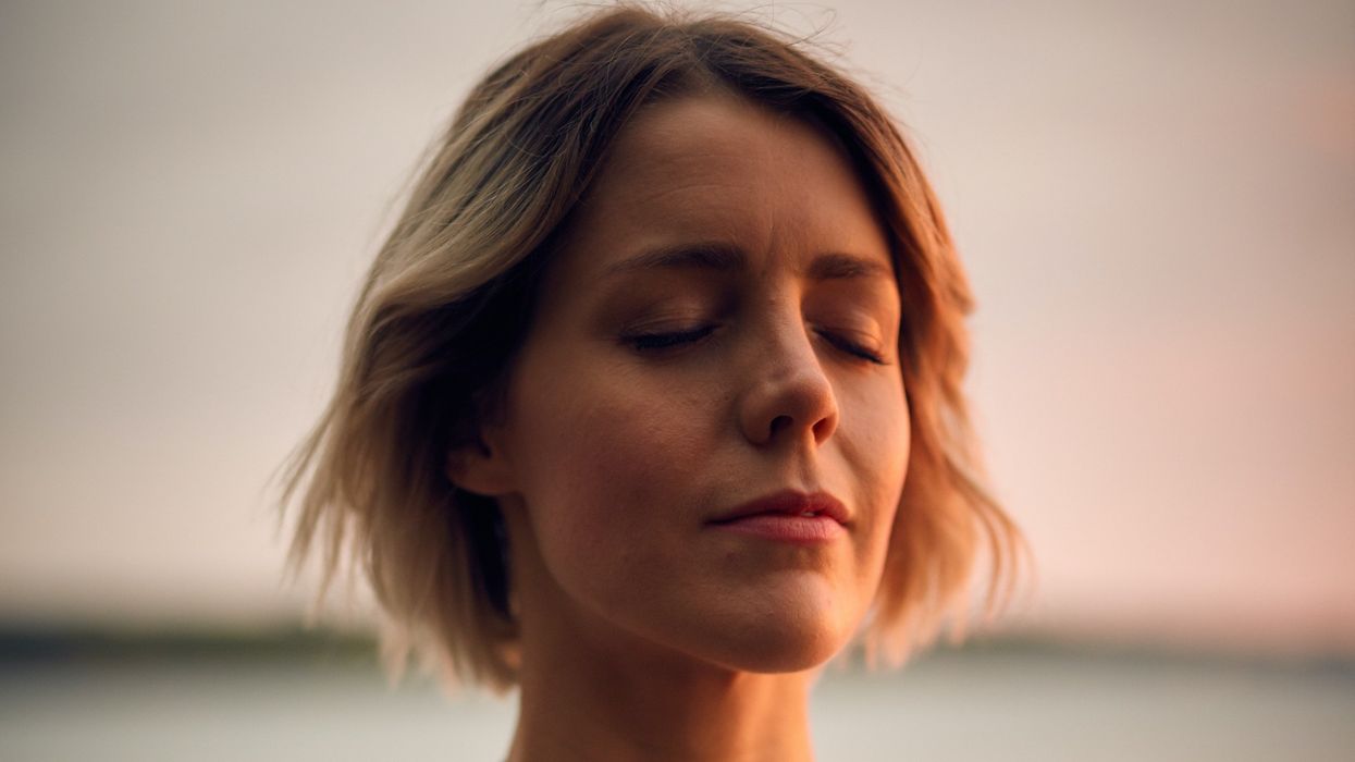 Woman at peace with her hand over her heart