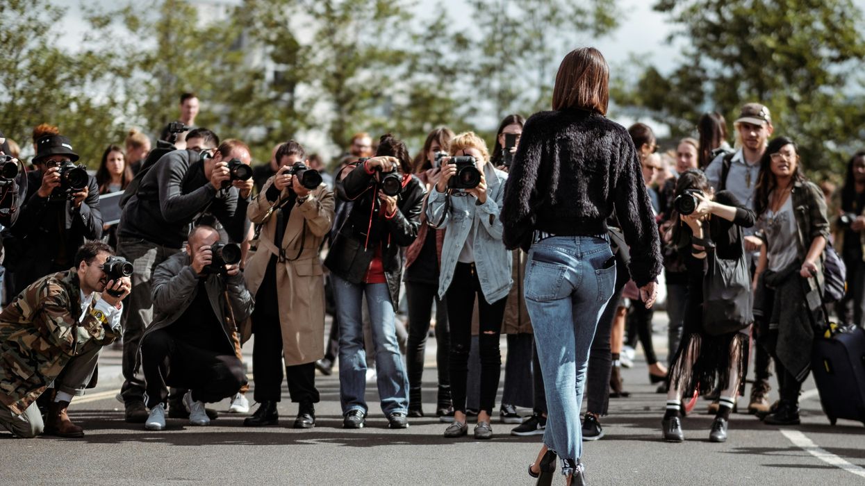 woman being photographed by group of photographers