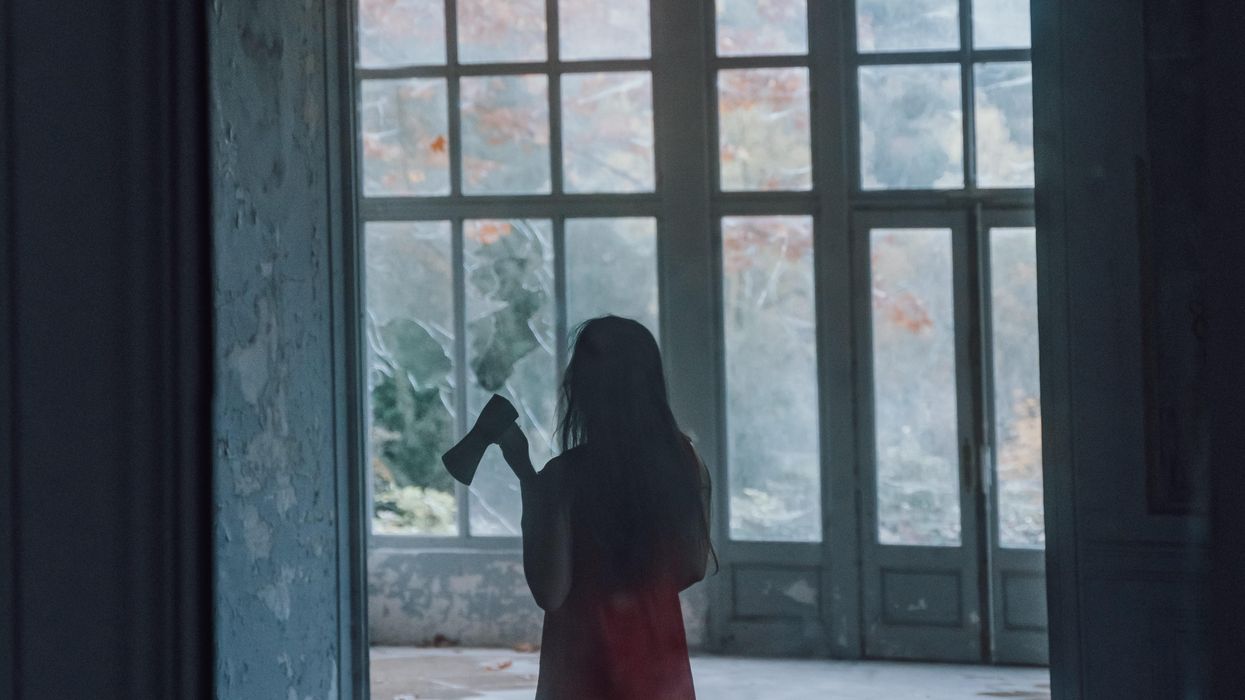 Woman carrying a hatchet