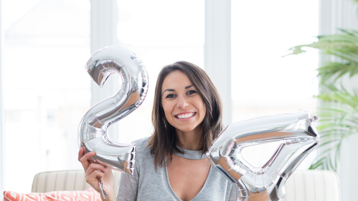 Woman celebrating her birthday with silver balloons that say, "24"