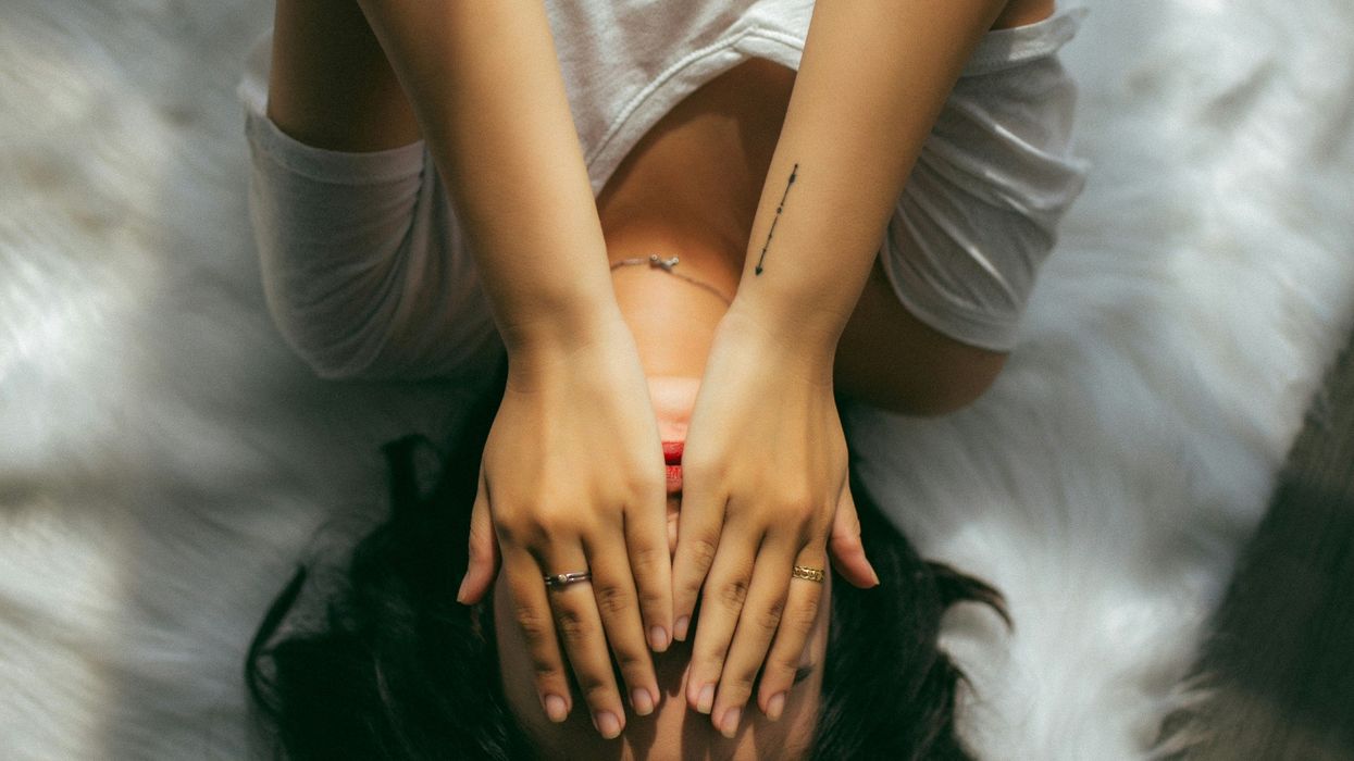 Woman covering face with both hands