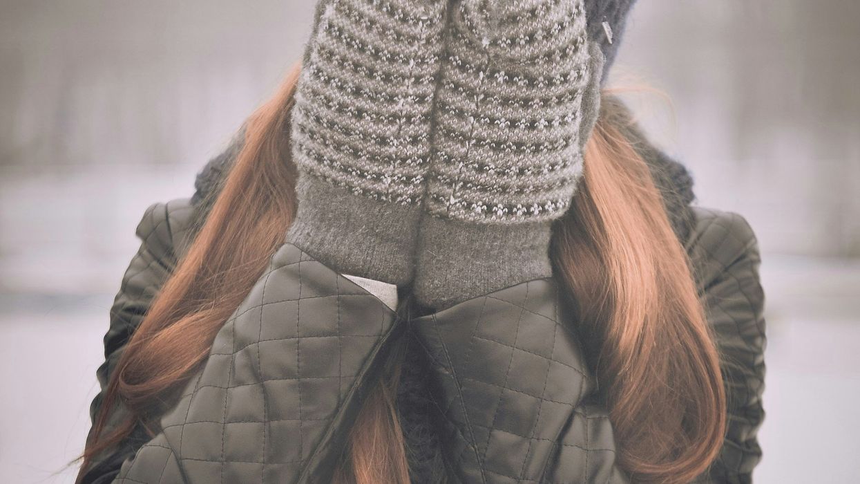 Woman covering her face with her hands