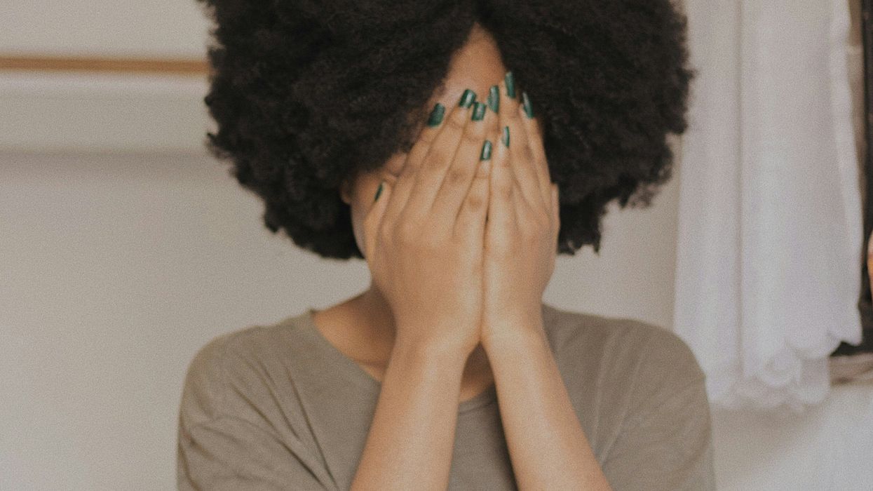 Woman covering her face
