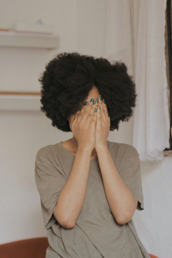 Woman covering her face