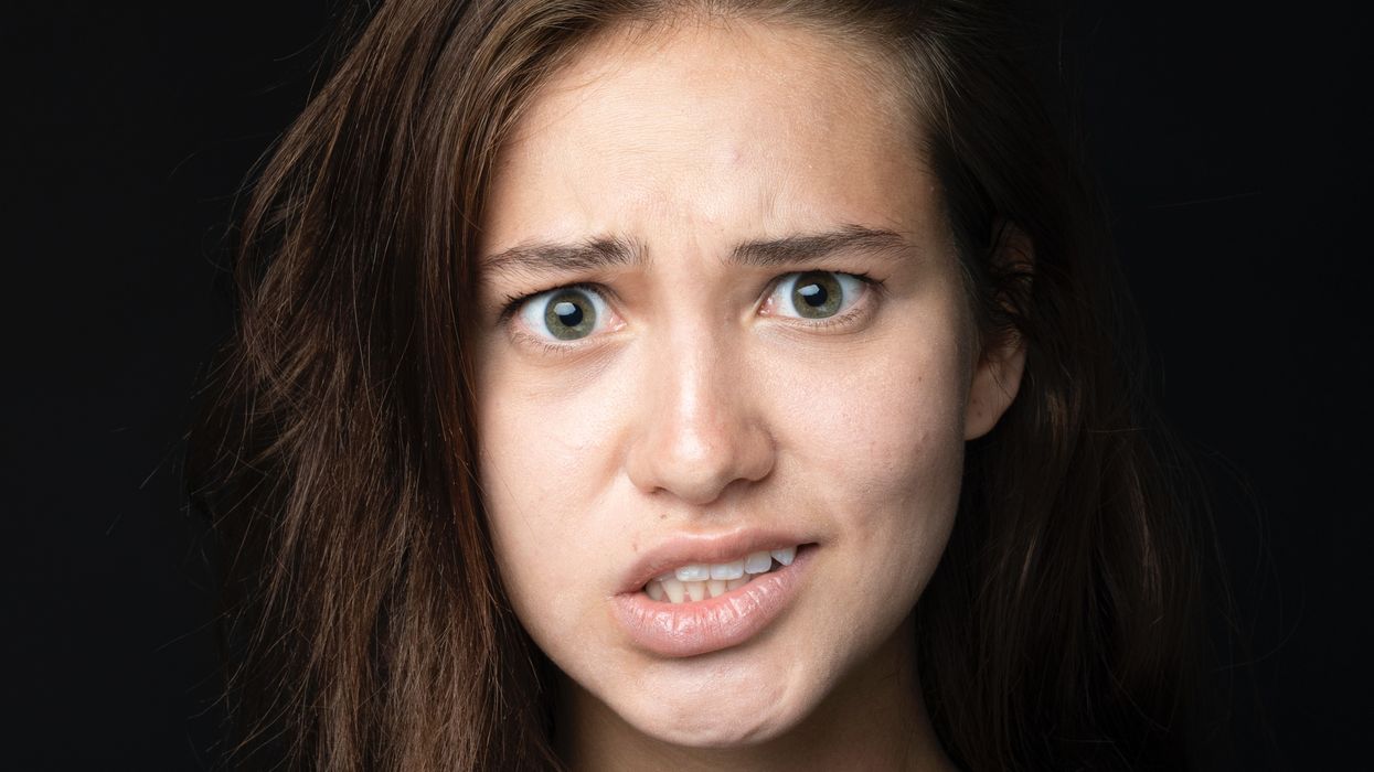 Woman cringing