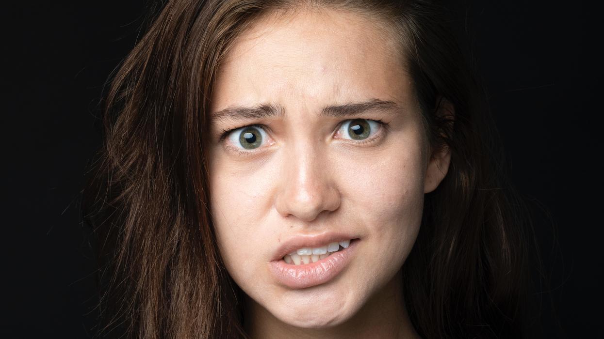 Woman cringing