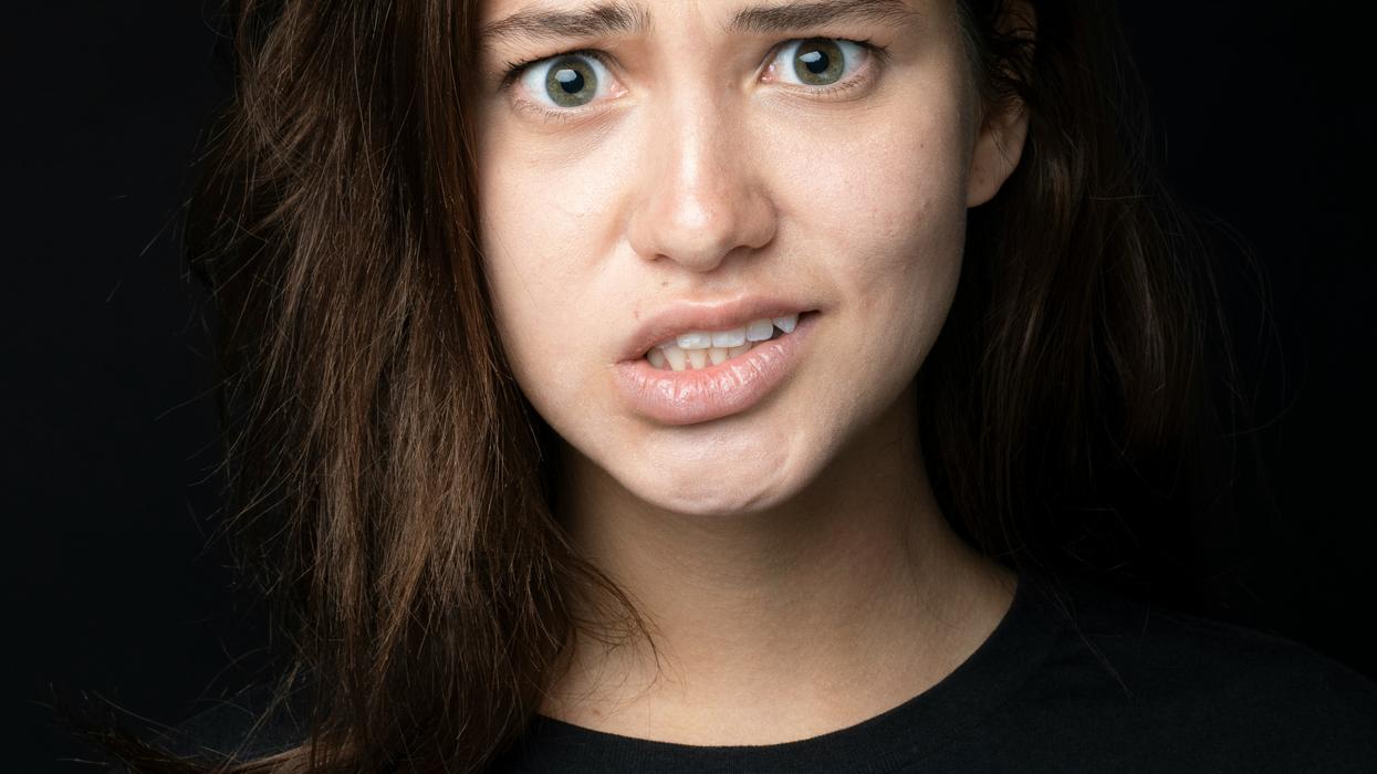 Woman cringing