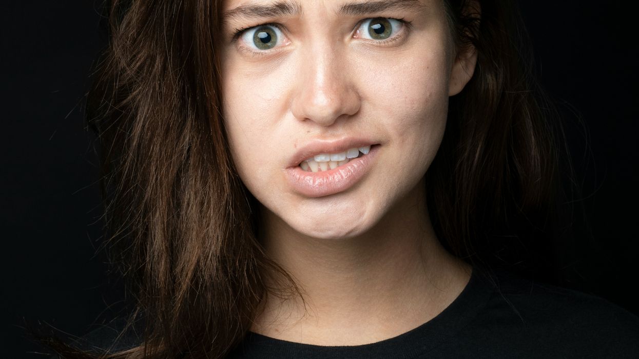 Woman cringing