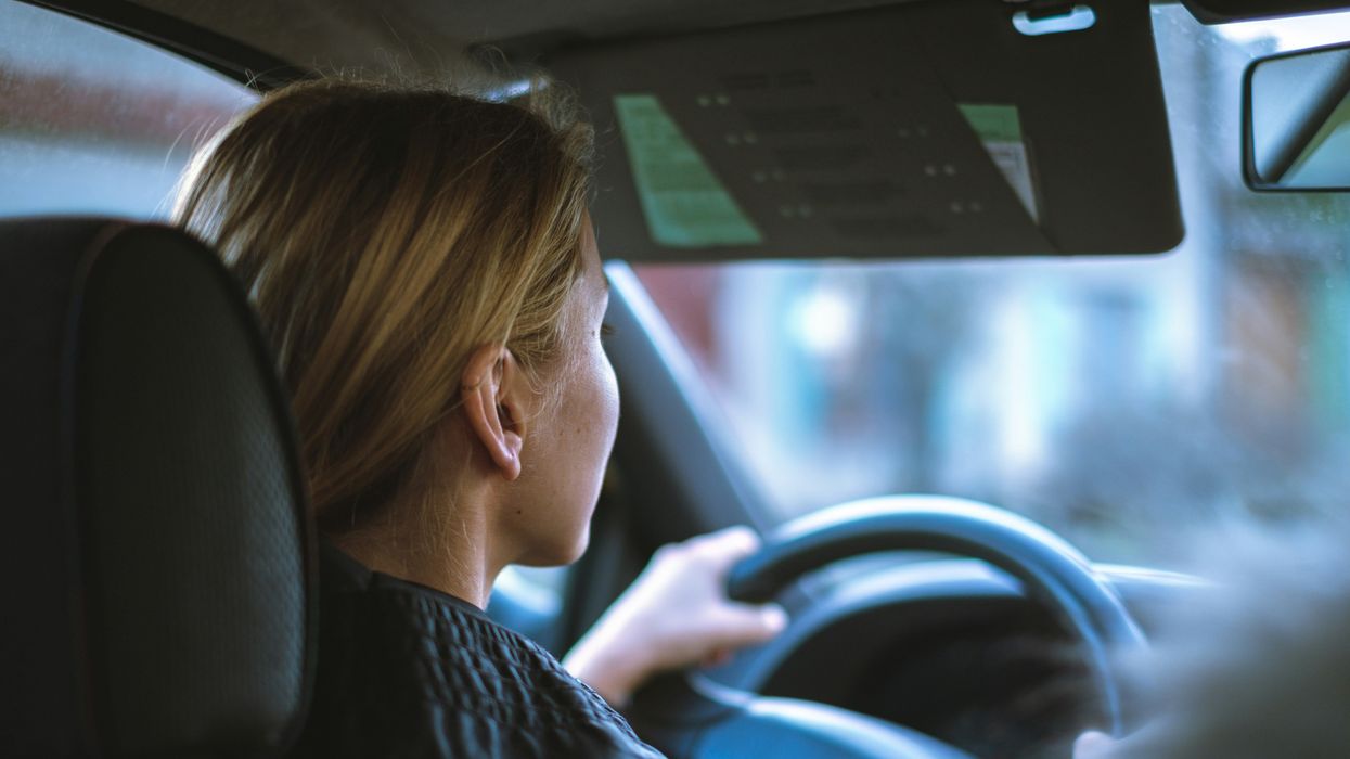 woman driving car with hands on a steering wheel