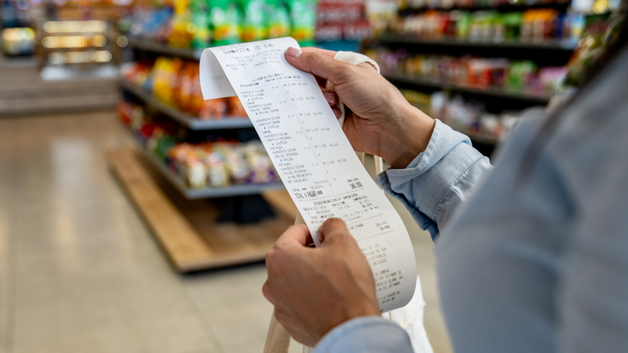 woman examines store receipt