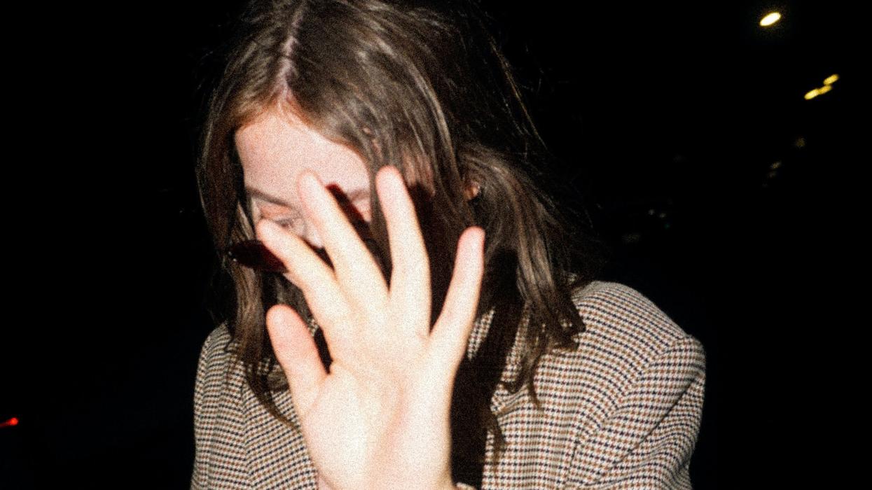 woman hiding her face from camera