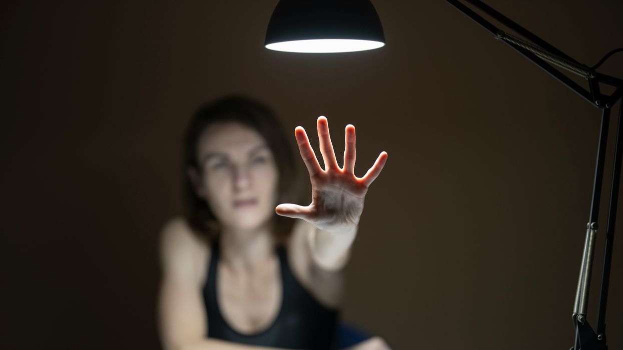 Woman holding her hand out.
