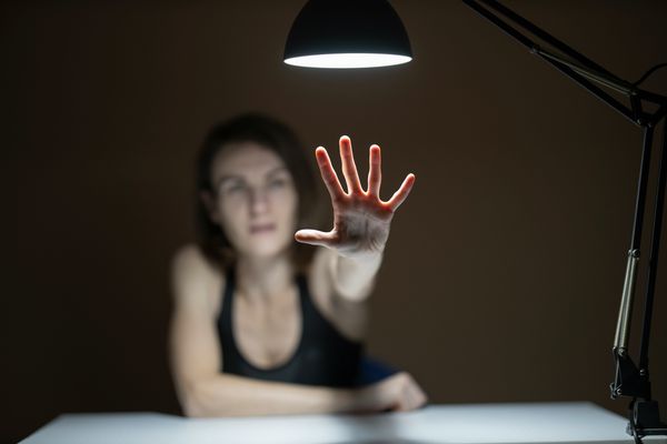 Woman holding her hand out.