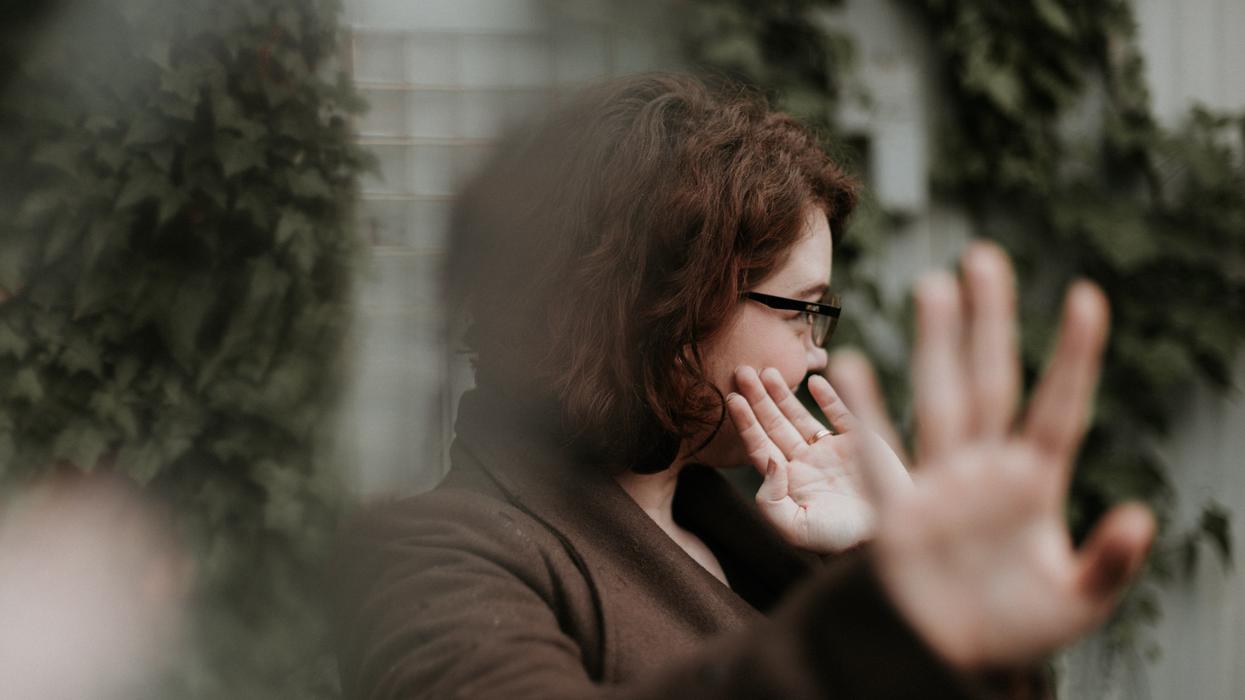 Woman holding her hands towards the camera