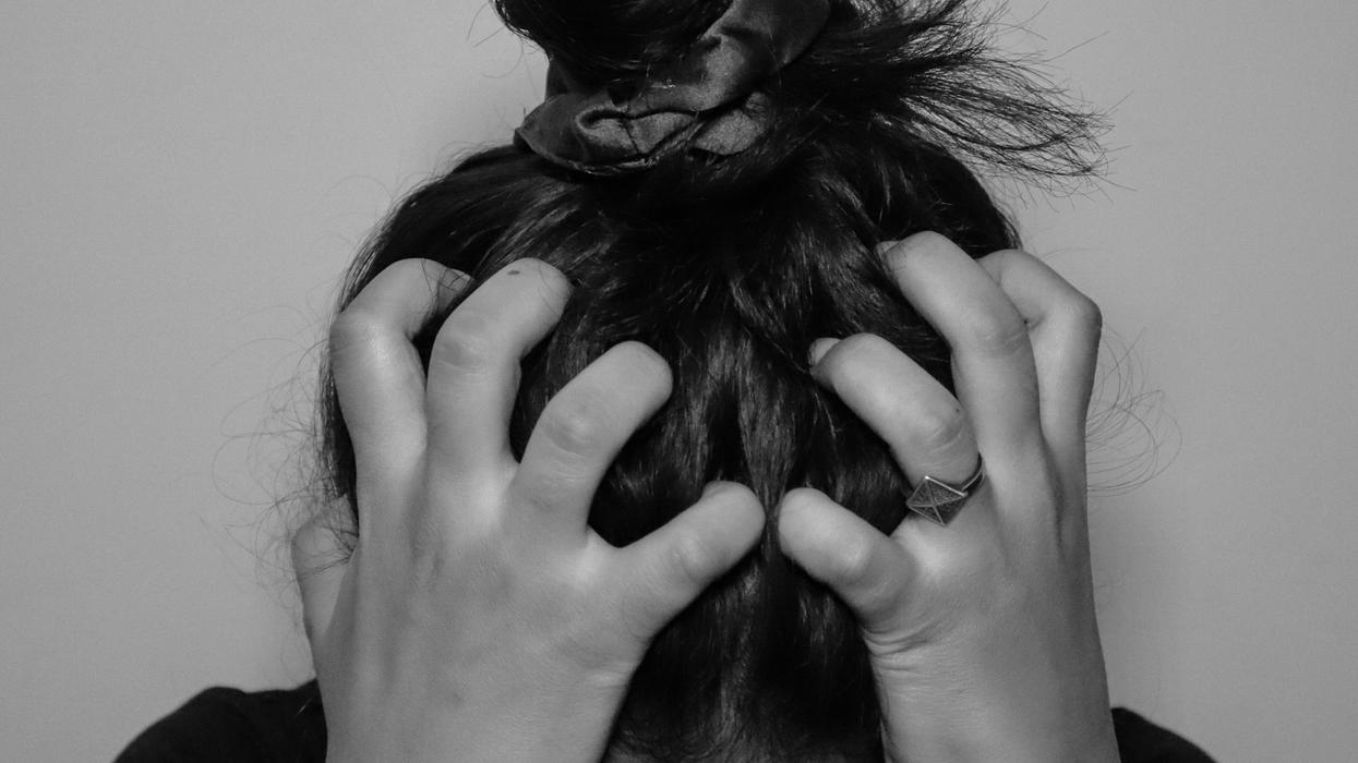Woman holding her head in her hands
