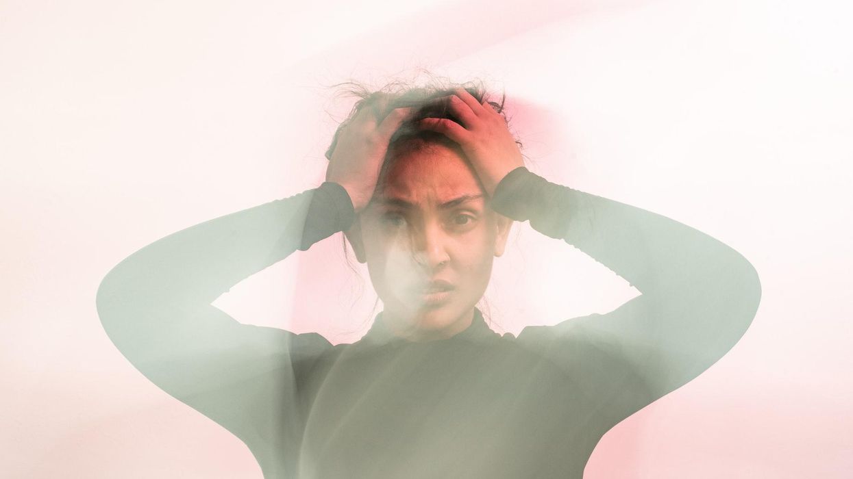 Woman holding her head looking frustrated