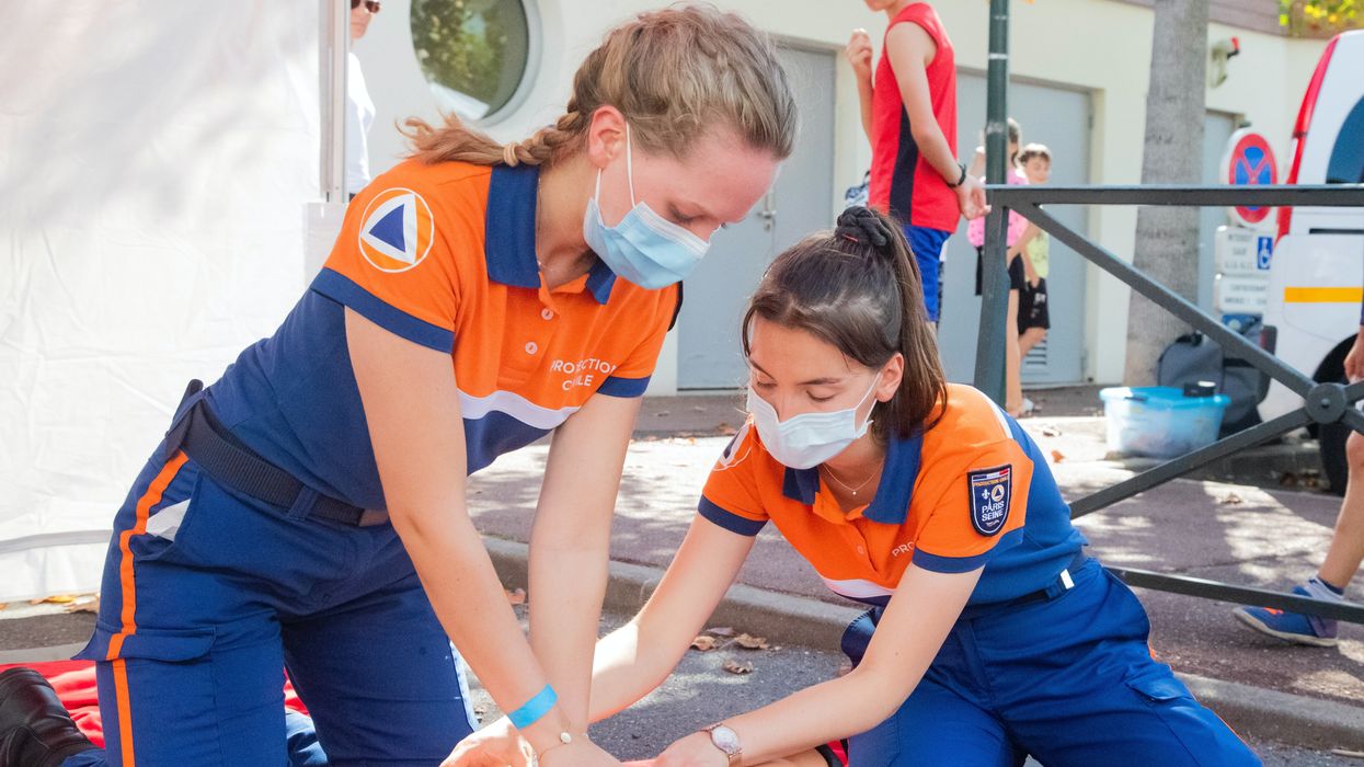 woman in blue t-shirt and blue pants holding baby