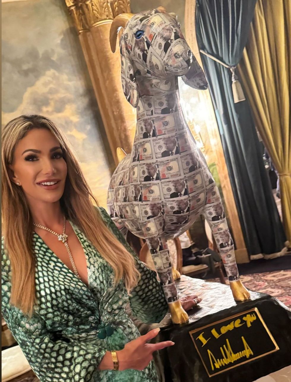 Woman in front of golden-hooved goat idol