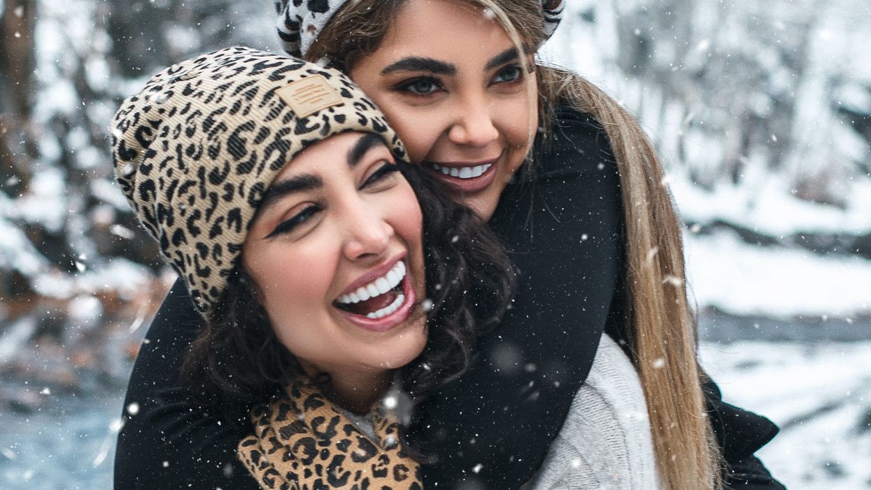 woman in gray coat and leopard scarf smiling