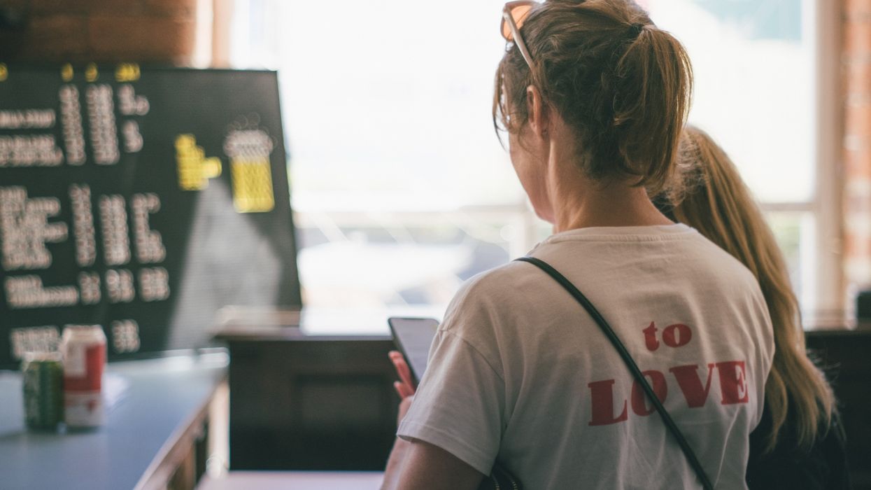 woman in white t-shirt looking at the window during daytime