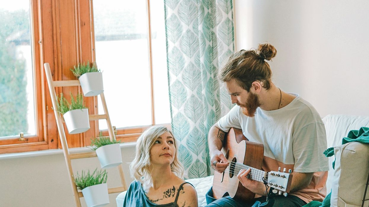 Woman listening to her boyfriend play guitar