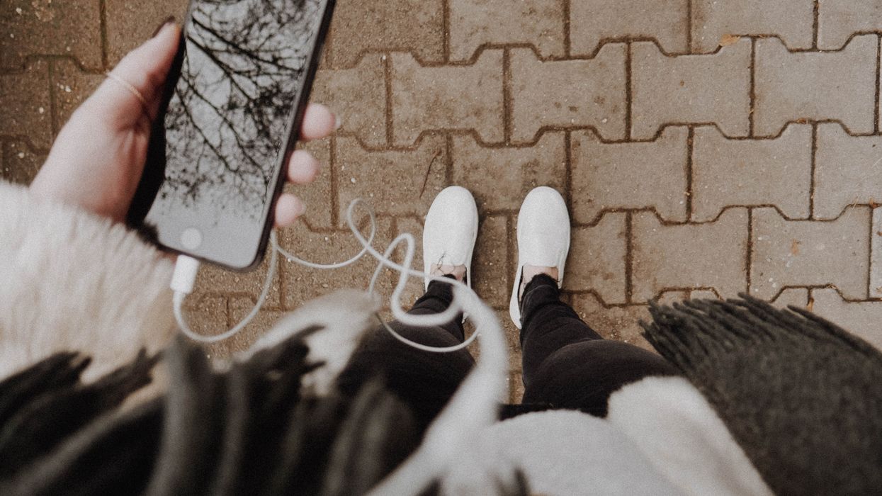 Woman listening to something on their iPhone