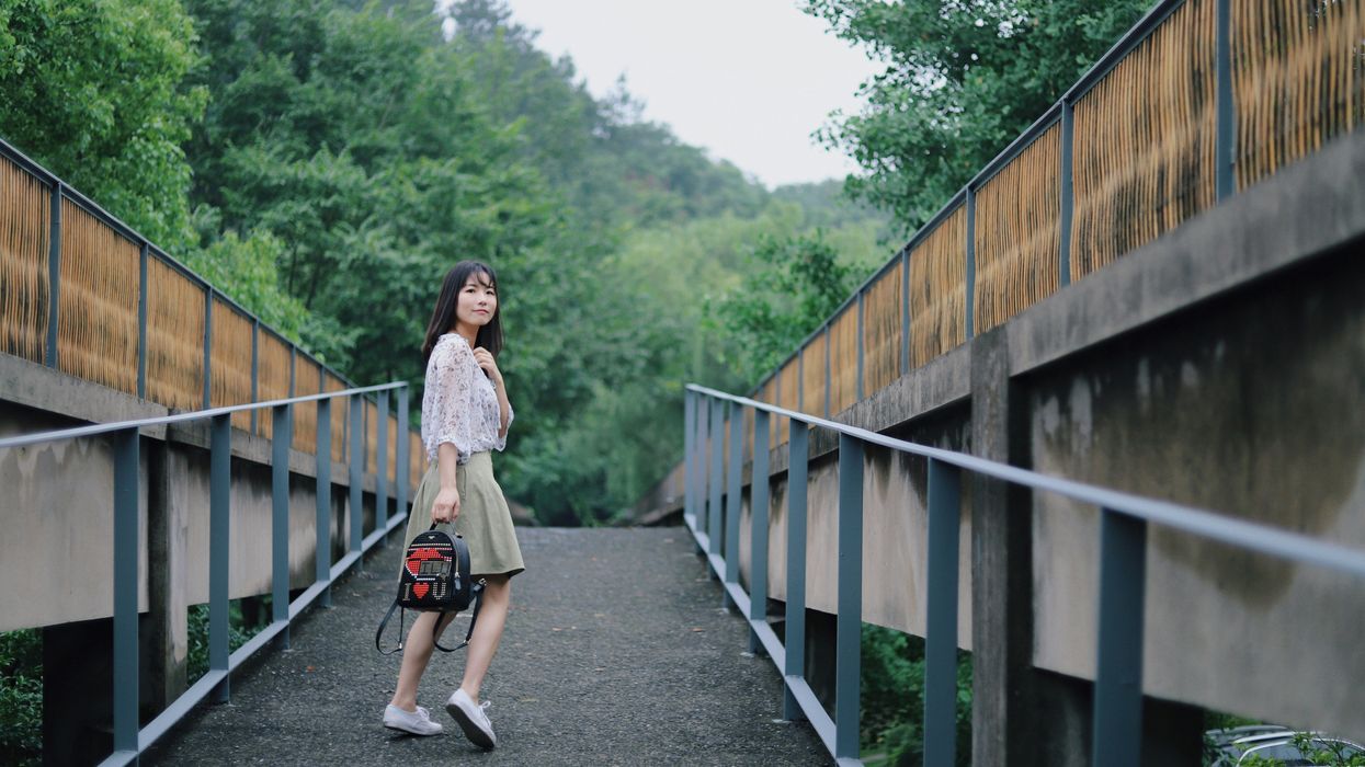 Woman looking over her shoulder while walking away