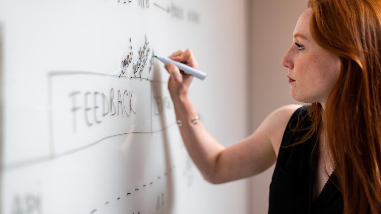 Woman noting feedback on corporate decision