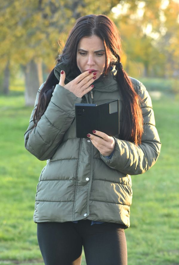Woman reading shocking text message