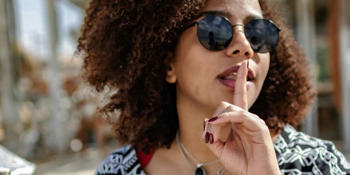 Woman says "shhh" to keep secrets