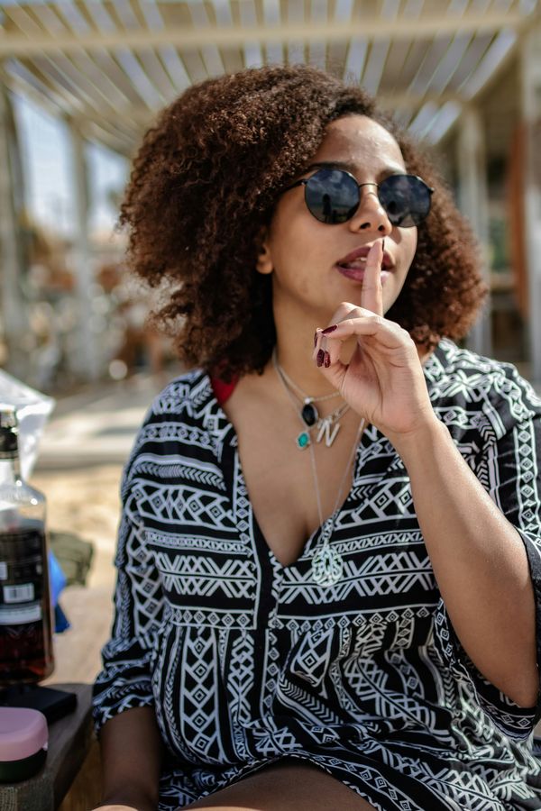 Woman says "shhh" to keep secrets