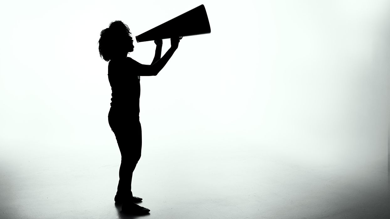 Woman shouting into horn