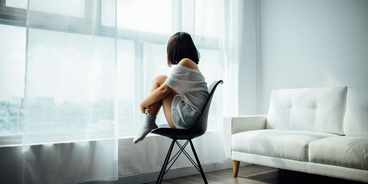 Woman sitting alone by window