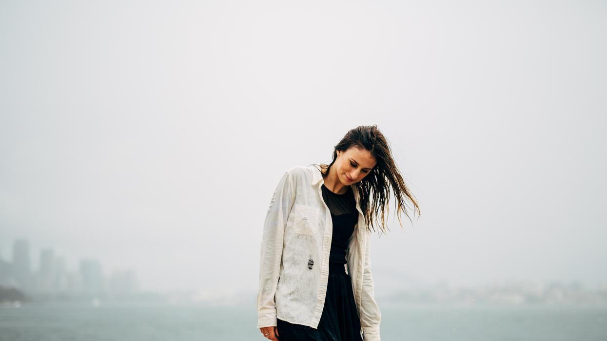 Woman standing alone in the rain