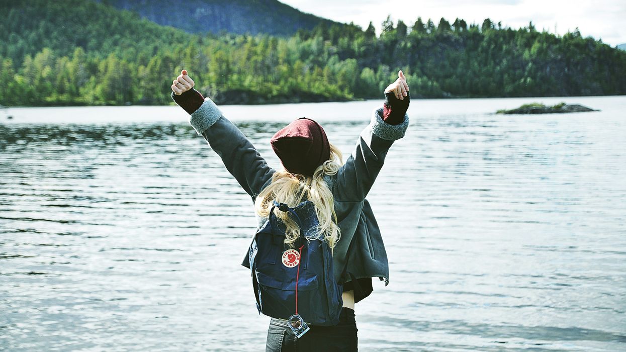 Woman victoriously raising her arms