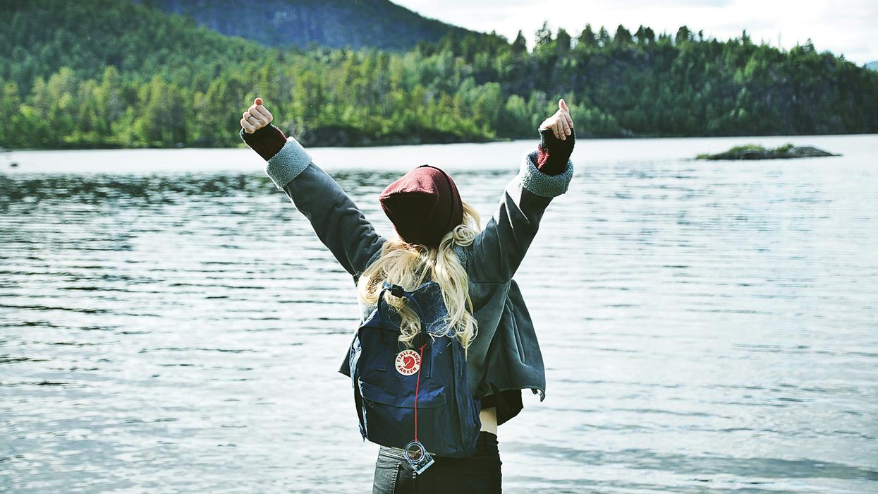 Woman victoriously raising her arms