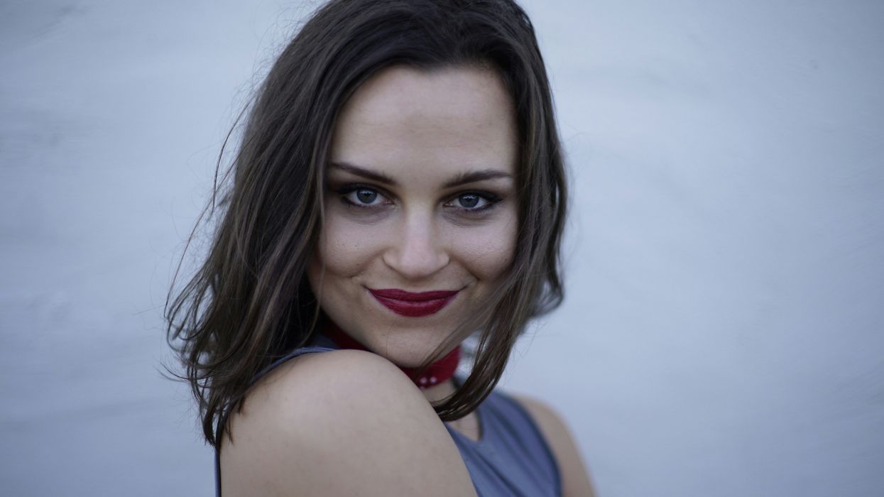 Woman with conspiratorial smile