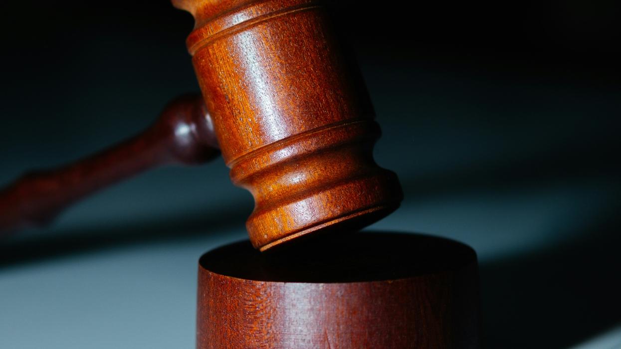 wooden gavel sitting on a wooden block