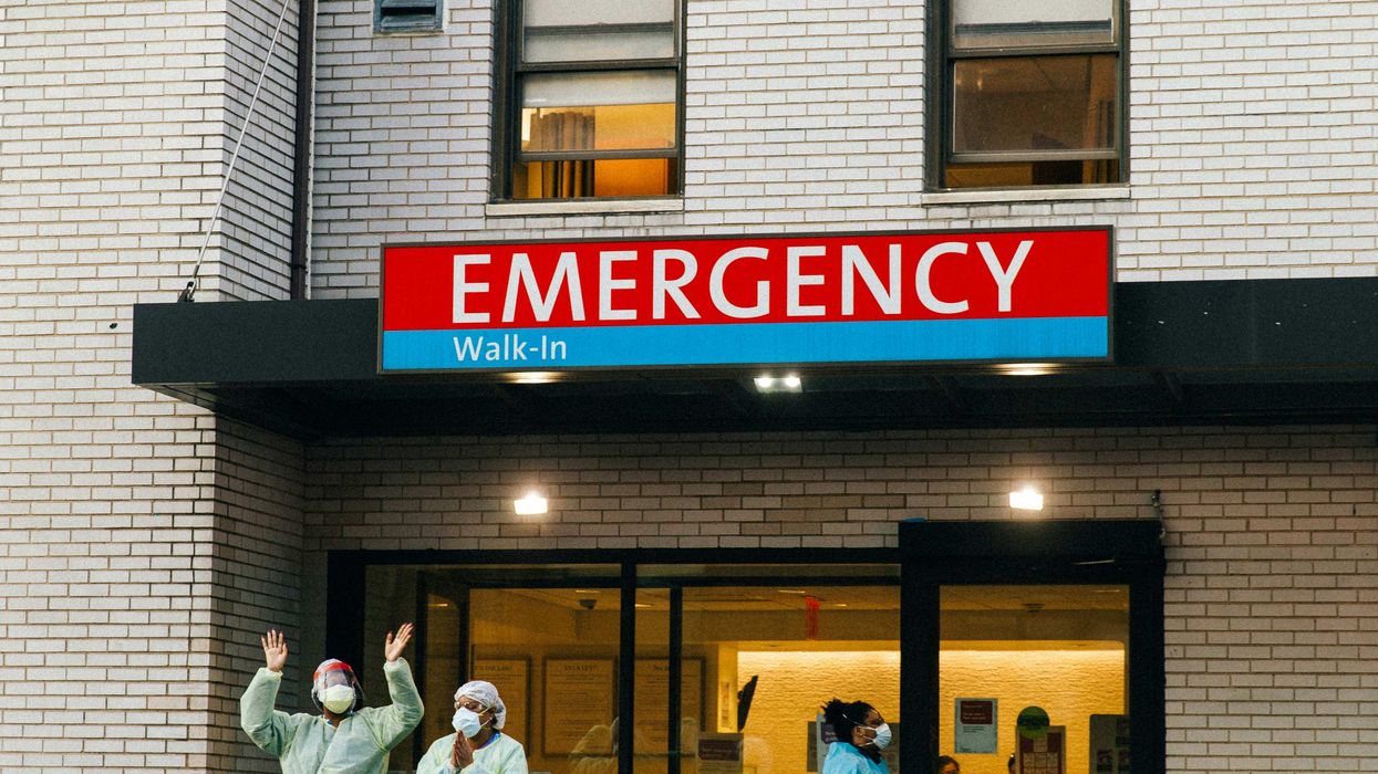 workers outside emergency room entrance