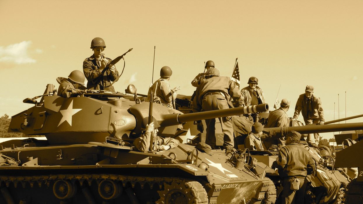 World War II Soldiers sitting and standing on battle tank