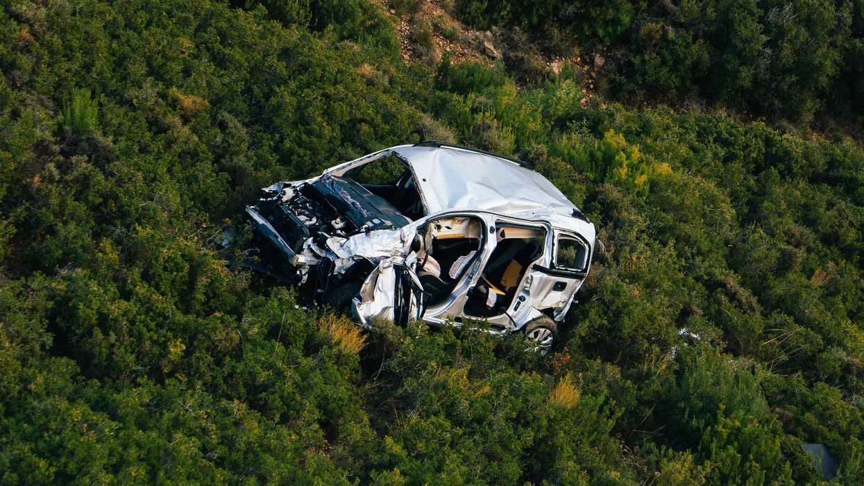 wrecked car on side of mountain