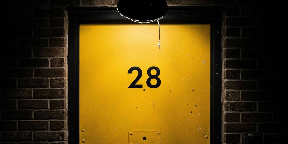 yellow door with number 28