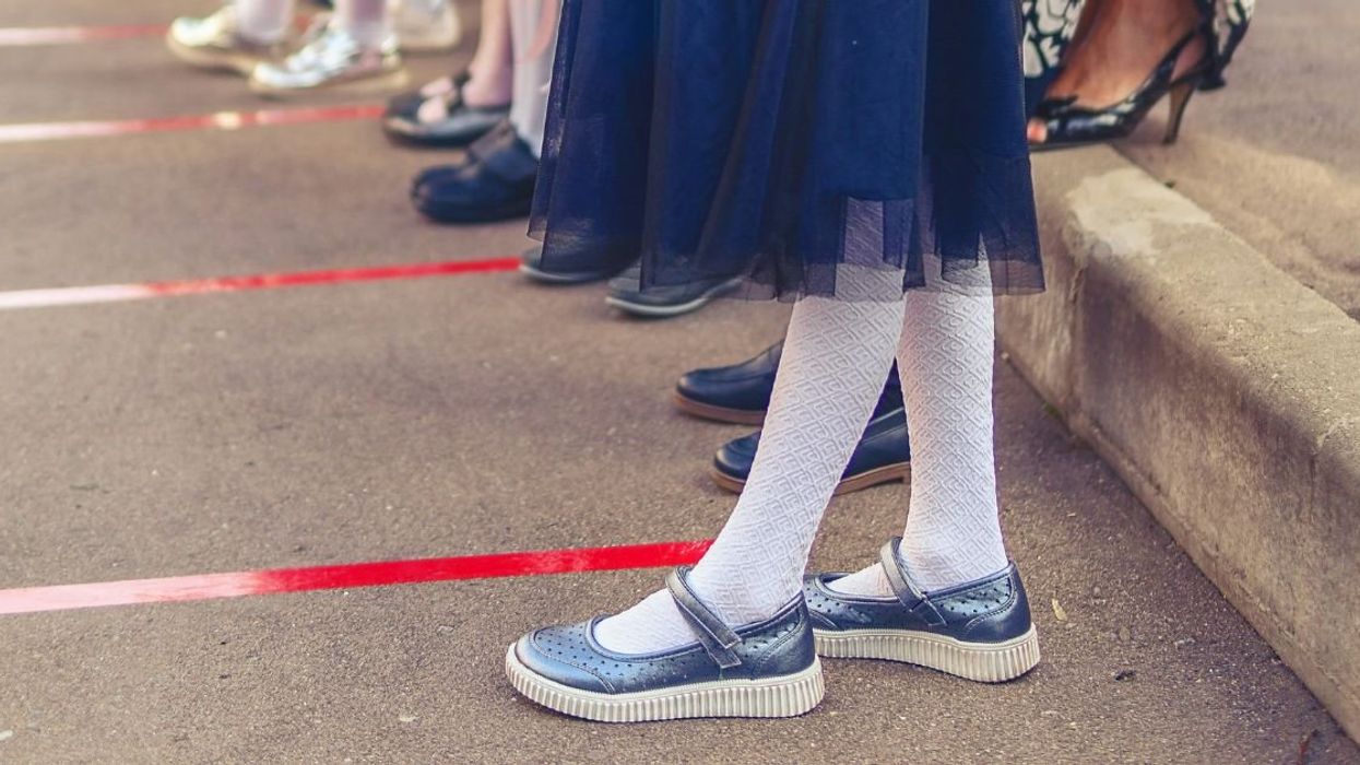 Young female student standing curbside