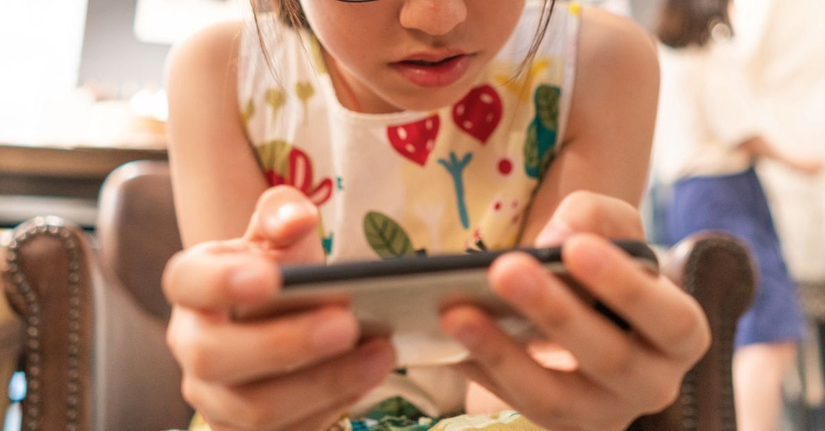 Young girl playing a mobile video game