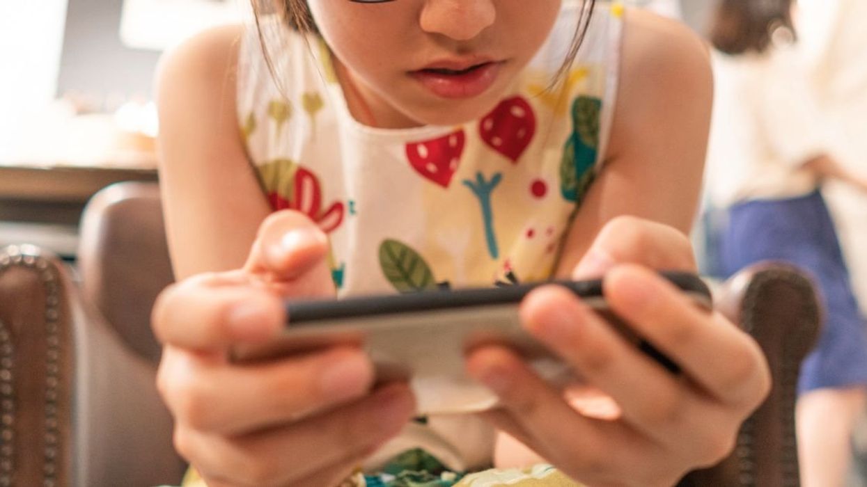 Young girl playing a mobile video game