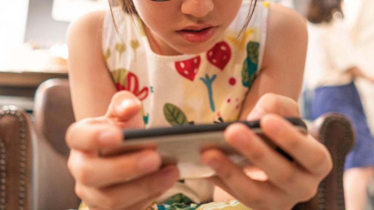 Young girl playing a mobile video game