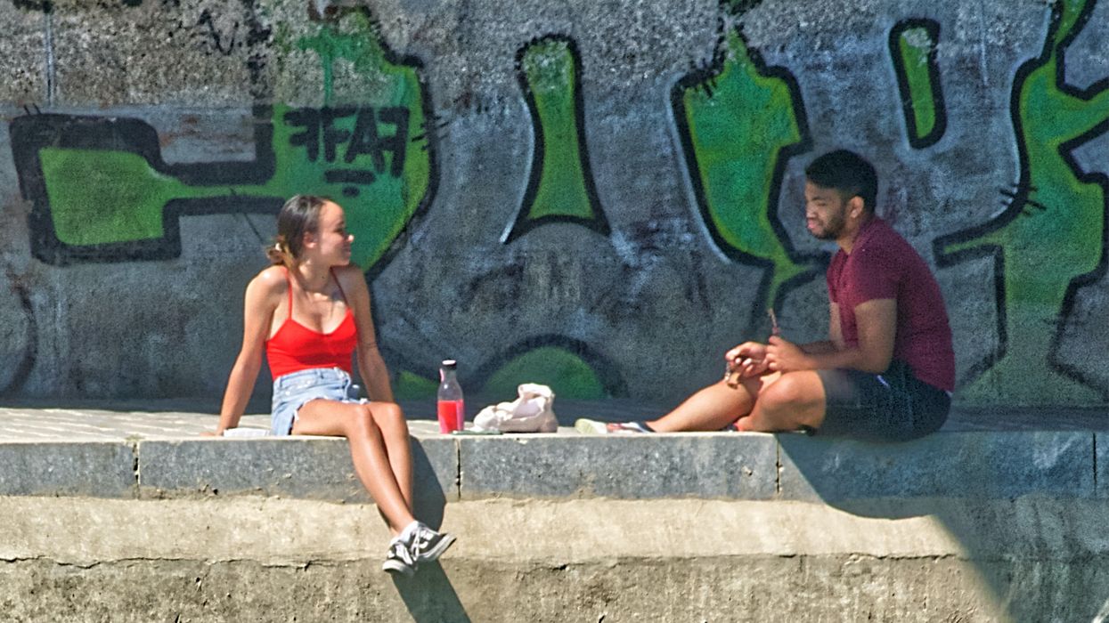 Young man and woman sitting and talking