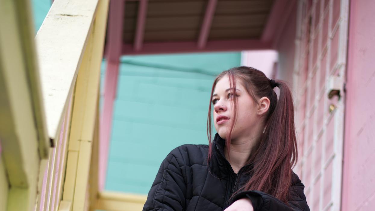 young woman sitting on stairs
