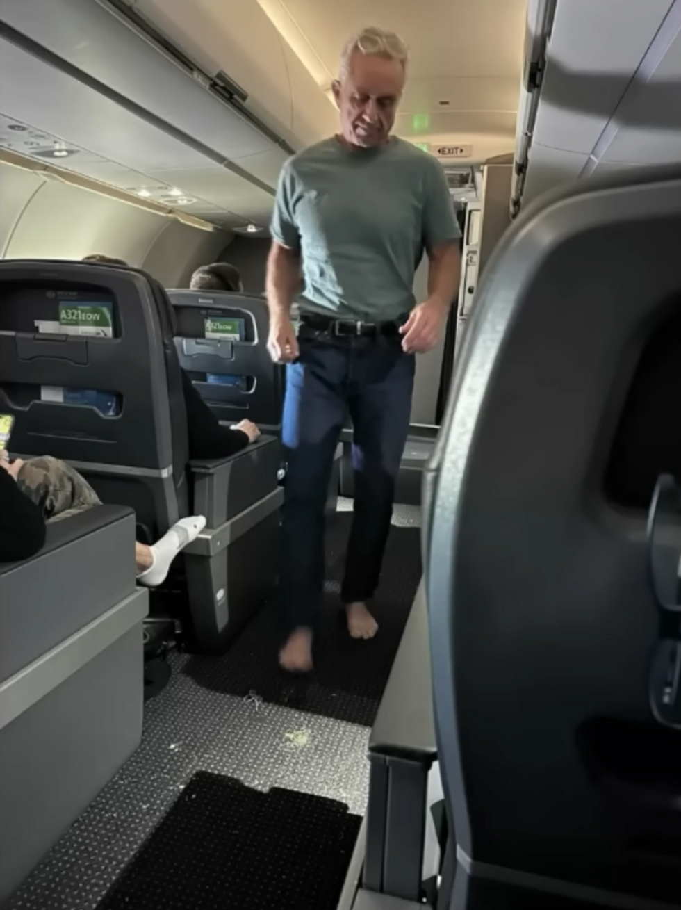 YouTube screenshot of Robert F. Kennedy barefoot on a plane